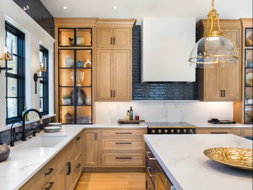 Custom kitchen with oak cabinets and modern glass doors.