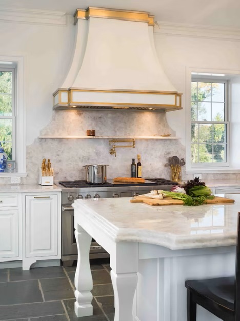 Custom kitchen cabinets with white paint and brass.
